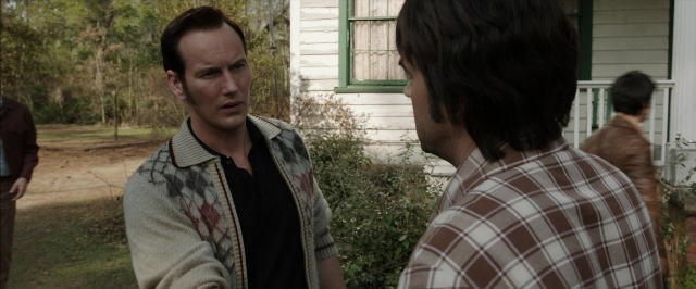 Wide shot frame from The Conjuring — standing, shirt, face