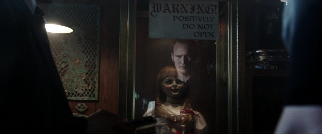 Wide shot frame from The Conjuring — standing, room, door