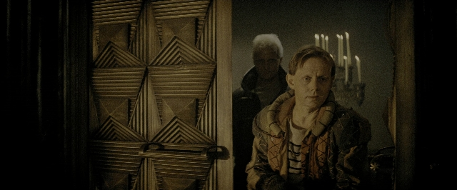 Wide shot frame from Blade Runner — standing, door, face