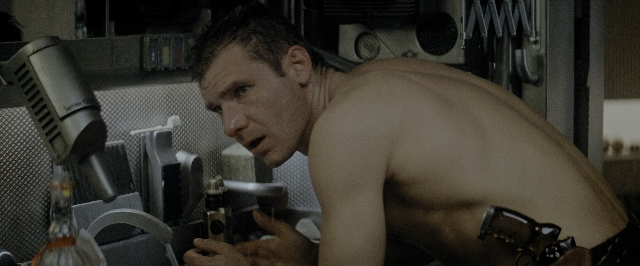 Wide shot frame from Blade Runner — standing, hand, gun