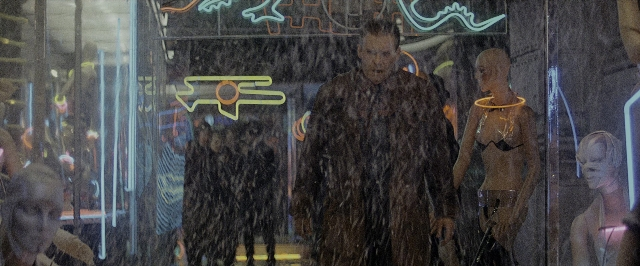 Wide shot frame from Blade Runner — standing, coat, face