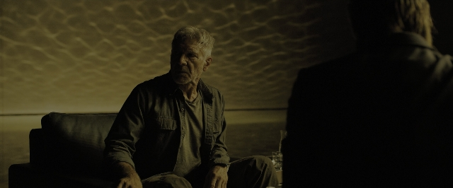Wide shot frame from Blade Runner 2049 — sitting, room, table
