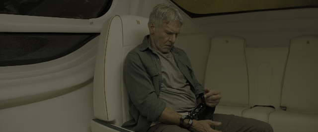 Wide shot frame from Blade Runner 2049 — sitting, car, hand