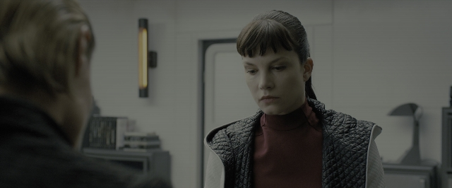Wide shot frame from Blade Runner 2049 — standing, room, face