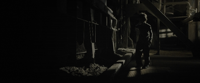 Wide shot frame from Blade Runner 2049 — standing, room, shirt