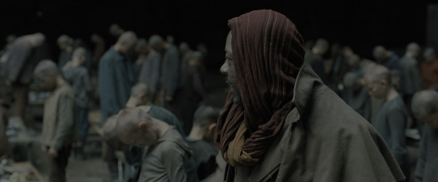 Wide shot frame from Blade Runner 2049 — standing, coat, night