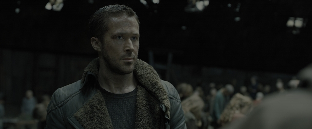 Wide shot frame from Blade Runner 2049 — standing, room, shirt
