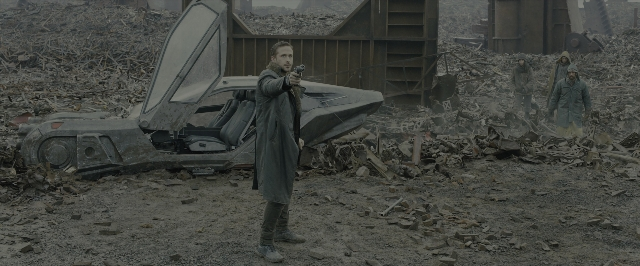 Wide shot frame from Blade Runner 2049 — standing, car, hand