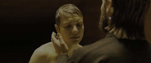 Medium shot frame from Blade Runner 2049 — standing, room, mirror