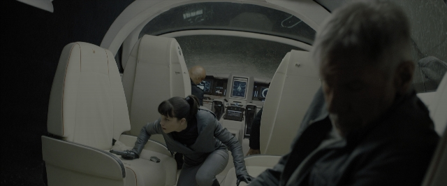 Wide shot frame from Blade Runner 2049 — sitting, standing, airplane