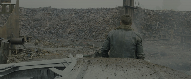 Wide shot frame from Blade Runner 2049 — standing, jacket, person
