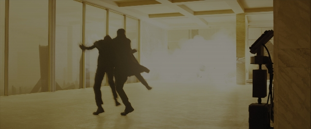 Wide shot frame from Blade Runner 2049 — room, kiss, suit