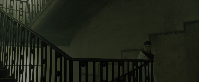 Wide shot frame from Blade Runner 2049 — standing, room, shirt