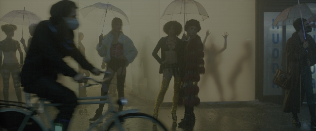 Wide shot frame from Blade Runner 2049 — standing, walking, street
