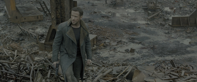 Wide shot frame from Blade Runner 2049 — walking, hand, gun