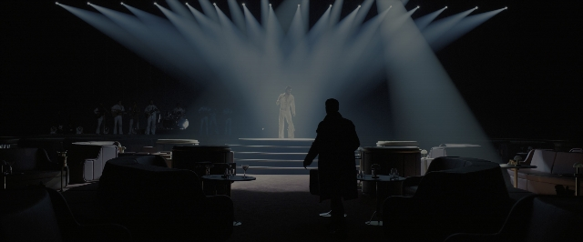 Wide shot frame from Blade Runner 2049 — standing, fountain, person