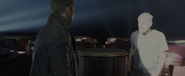 Wide shot frame from Blade Runner 2049 — standing, room, table