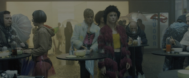 Wide shot frame from Blade Runner 2049 — sitting, standing, plate