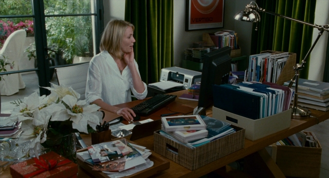 Wide shot frame from The Holiday — sitting, desk, book