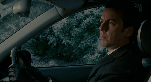 Wide shot frame from The Holiday — sitting, street, car