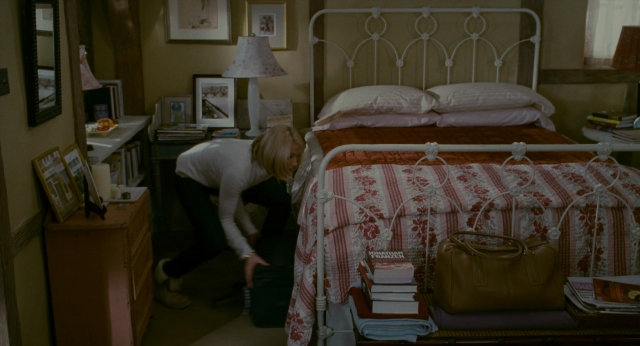Wide shot frame from The Holiday — desk, room, bed