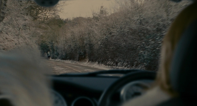 Frame from The Holiday — street, car, face