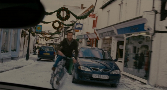 Wide shot frame from The Holiday — street, car, bicycle