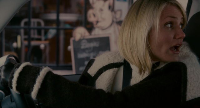 Wide shot frame from The Holiday — sitting, car, face