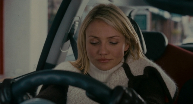 Medium shot frame from The Holiday — sitting, street, car