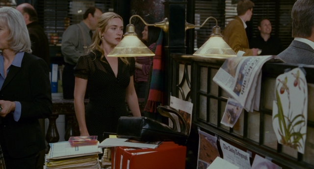 Wide shot frame from The Holiday — standing, room, hand