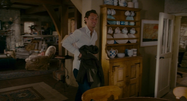 Wide shot frame from The Holiday — standing, room, door
