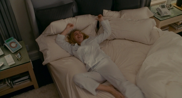 Wide shot frame from The Holiday — room, bed, phone