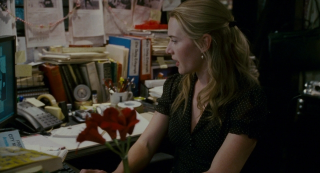 Wide shot frame from The Holiday — sitting, book, phone