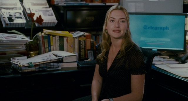 Wide shot frame from The Holiday — sitting, book, dress