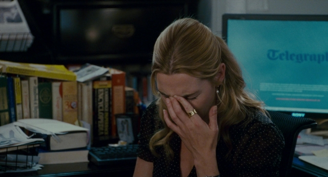 Wide shot frame from The Holiday — sitting, book, office