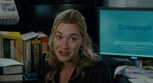 Medium shot frame from The Holiday — sitting, book, office