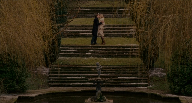 Wide shot frame from The Holiday — standing, coat, bird