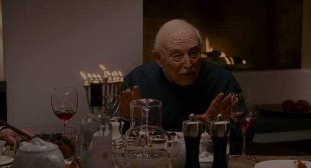 Wide shot frame from The Holiday — sitting, room, table