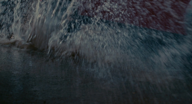 Wide shot frame from The Holiday — street, water, fountain