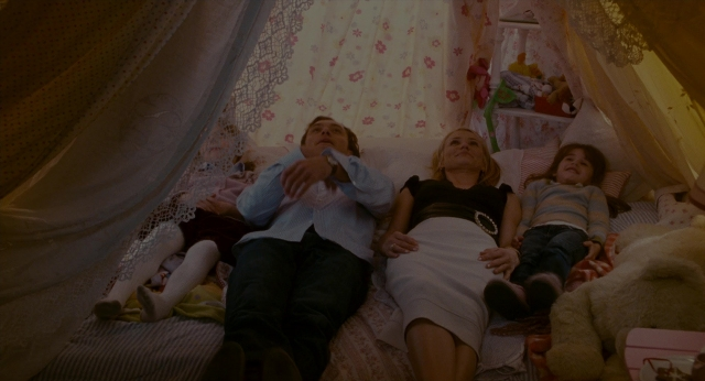 Wide shot frame from The Holiday — sitting, bed, shirt