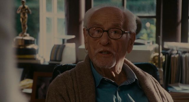 Wide shot frame from The Holiday — sitting, room, shirt