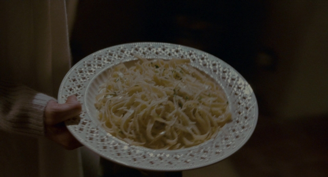 Wide shot frame from The Holiday — plate, room, hand