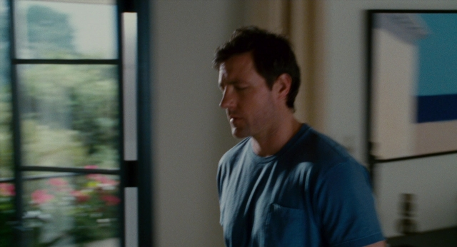 Wide shot frame from The Holiday — standing, room, shirt