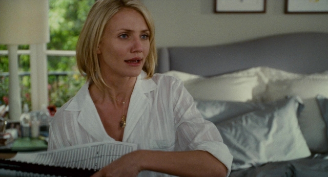 Wide shot frame from The Holiday — sitting, book, room