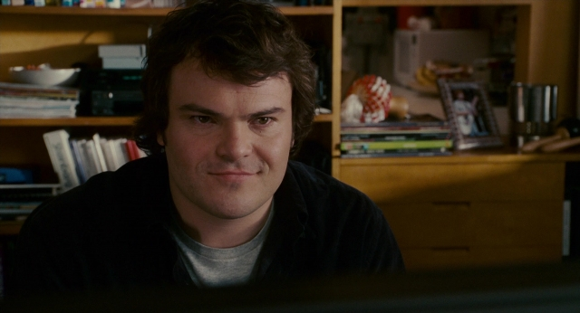 Medium shot frame from The Holiday — sitting, book, room