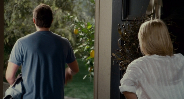 Wide shot frame from The Holiday — standing, door, hand