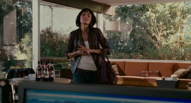 Wide shot frame from The Holiday — standing, room, table