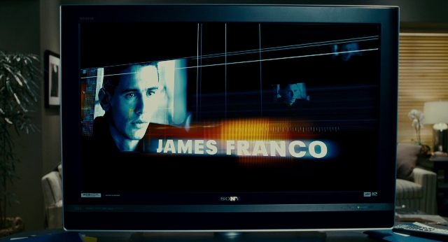 Wide shot frame from The Holiday — room, suit, tie