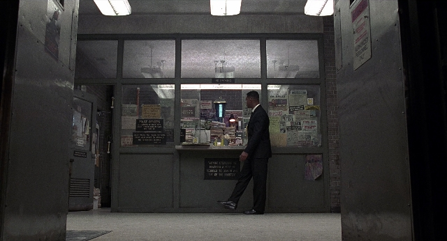 Wide shot frame from Men in Black — walking, door, suit