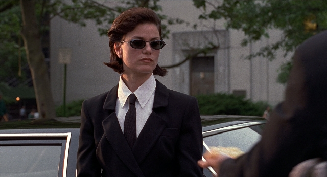 Wide shot frame from Men in Black — standing, street, car